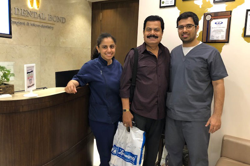 Smiling patient with dentist